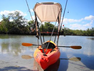 Bimini top for sit on top kayak with fishing rod holders attached to