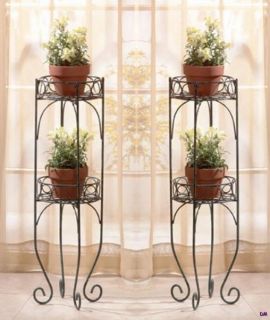 Lacy scrolls in a verdigris style finish comprise this two shelf plant