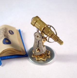 Miniature Medieval Telescope and Gold Illuminated Open Astrology Book