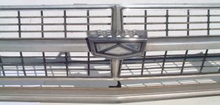 This is an original grill and passengers side headlight bezel from a